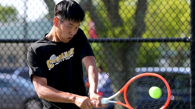 Commack's Eddie Liao returns the backhand volley against Haborfields' Chris...