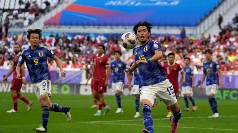 Japan's Koki Machida runs for the ball during the Asian...