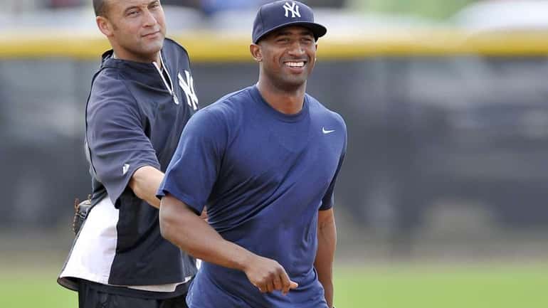 Yankees shortstop Derek Jeter has some fun with infielder Eduardo...