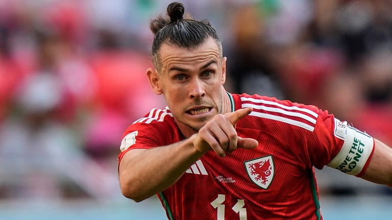 Wales' Gareth Bale wears an armband reading "save the planet"...