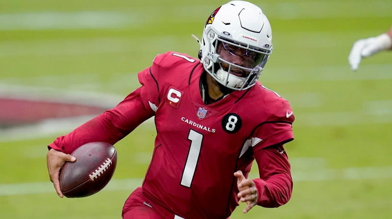 Cardinals quarterback Kyler Murray scrambles against the Lions during the first...