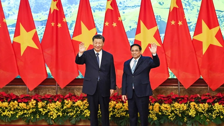Vietnam's Prime Minister Pham Minh Chinh, right, and the China's...