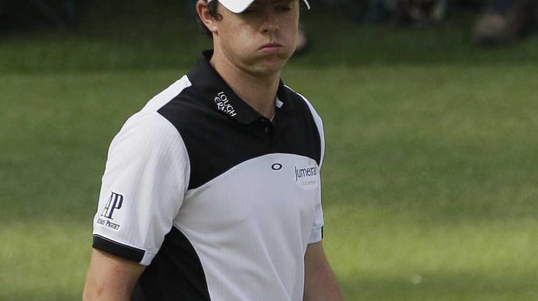 Rory McIlroy reacts to a shot that nearly rolled in...