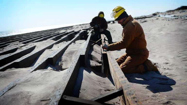 Contractors work to rebuild a section of the Robert Moses...