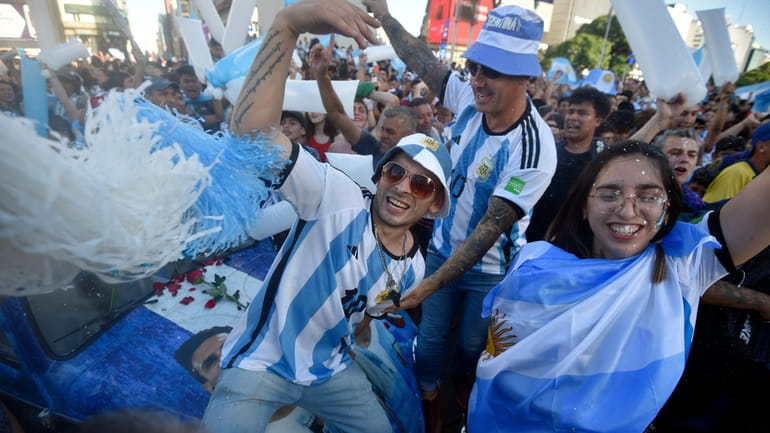 Argentina soccer fans celebrate their team's victory over Croatia at...