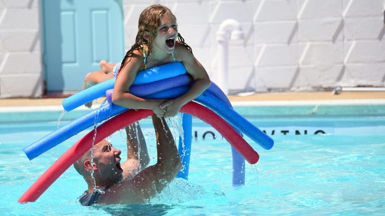 Samantha Rosenthal, 7, of Merrick, cools off at MECA Pool...