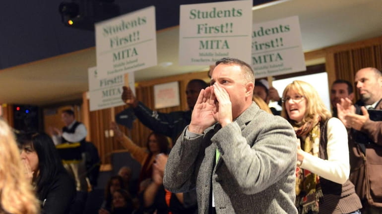 Kevin Coyne, president of the Brentwood Teachers Association, chants, "Get...