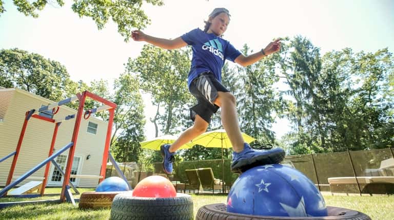Clint Daly, 12, seen on an obstacle course July 18...