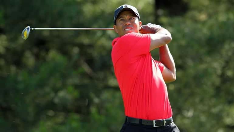Tiger Woods hits his tee shot on the par 4...