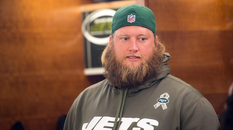 New York Jets center Nick Mangold (74) talks to the...