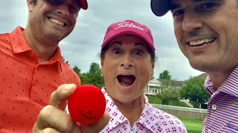 Carol Goldman with the golf ball she used to ace...