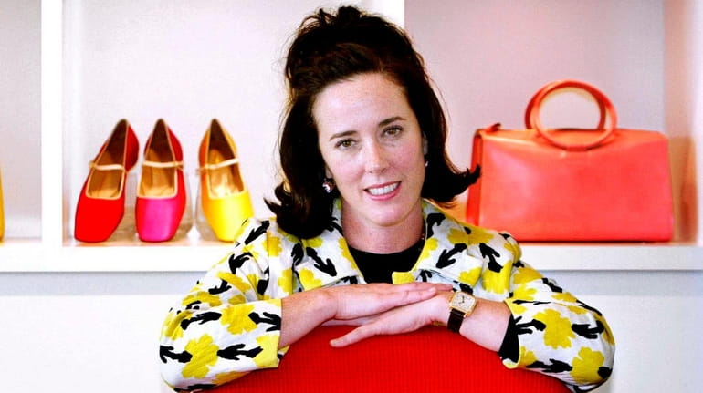 Kate Spade poses with handbags and shoes from her collection...