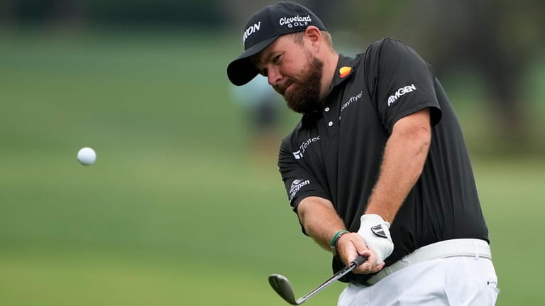 Shane Lowry, of Ireland, chips to the green on the...