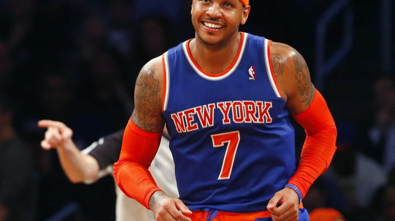 Carmelo Anthony smiles during the second half of a game...