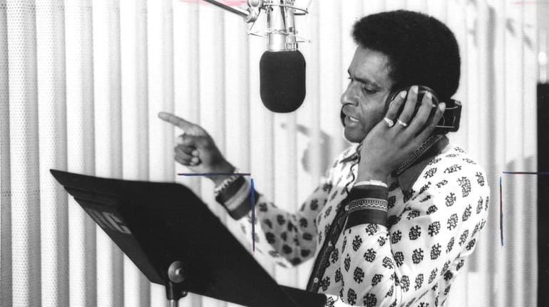  Groundbreaking country music star Charley Pride recording in the studio.