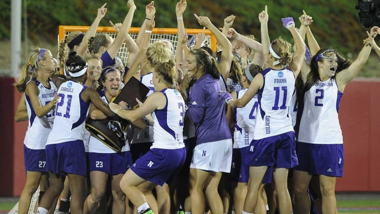 Northwestern celebrates their 8-6 win over Syracuse for the NCAA...