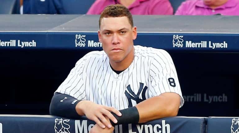 Aaron Judge #99 of the New York Yankees looks on...