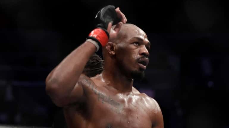 Jon Jones celebrates after defeating Anthony Smith following their light...