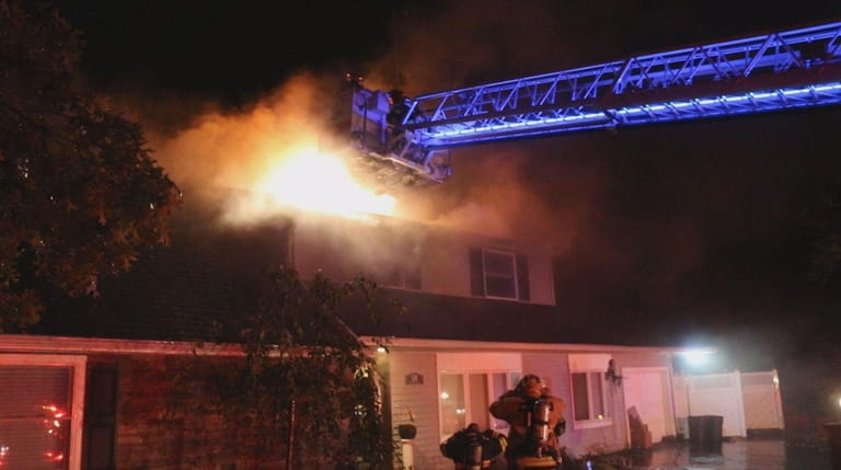 Fiirefighters fight a blaze in a house on Arden Lane...