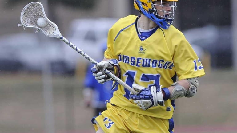 Comsewogue's Kenny Scotland drives the ball against Hauppauge in the...