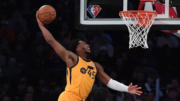 Utah Jazz guard Donovan Mitchell goes up for a dunk...