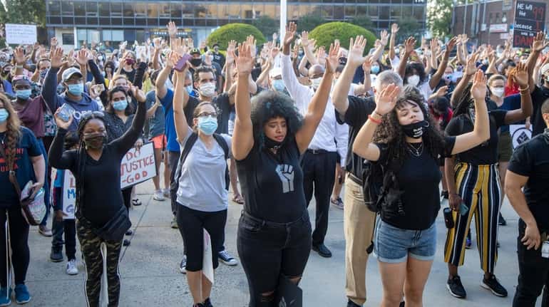 Racially and ethnically diverse demonstrators protest against police brutality in...