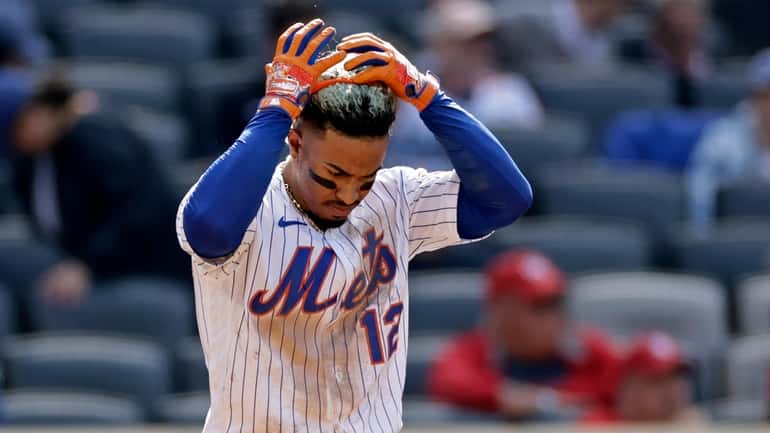 Mets' Francisco Lindor reacts after striking out during the ninth...