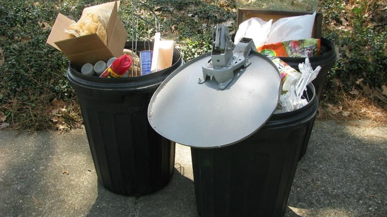 A photo shows trash inside garbage receptacles.