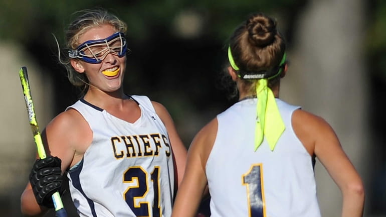 Mackenzie Conkling of Massapequa, right, gets congratulated by teammate Shannon...