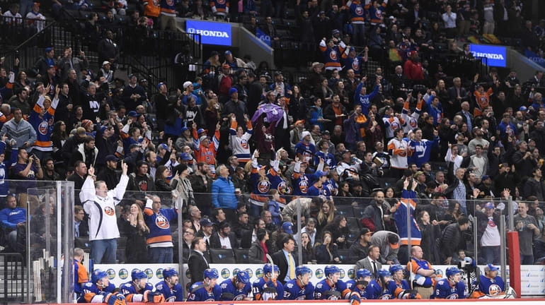 New York Islanders fans celebrate a goal by New York...