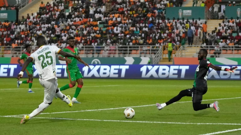 Mali's Lassine Sinayoko, left, scores his side's second goal during...