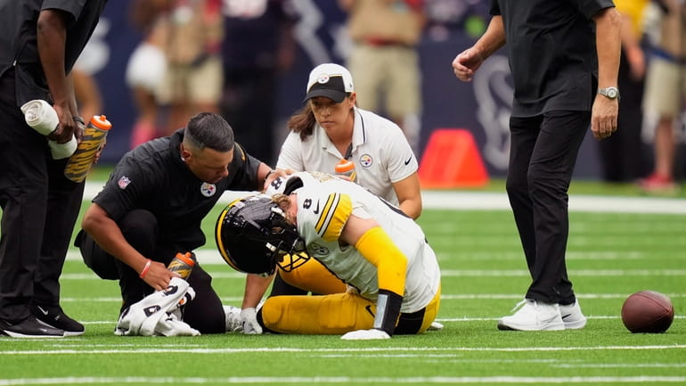 Pittsburgh Steelers quarterback Kenny Pickett (8) is helped after an...
