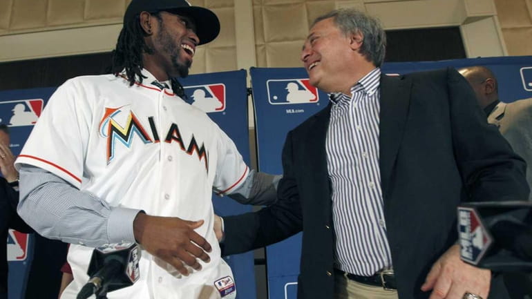Miami Marlins owner Jeffrey Loria, right, and Jose Reyes share...