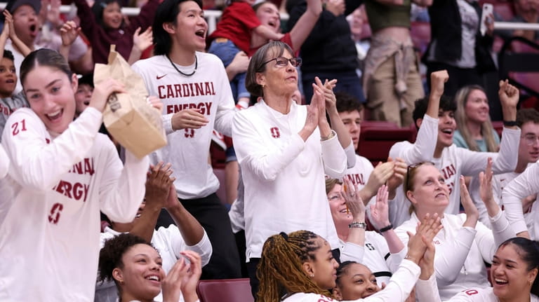 Stanford basketball head coach Tara VanDerveer, center, applauds as the...
