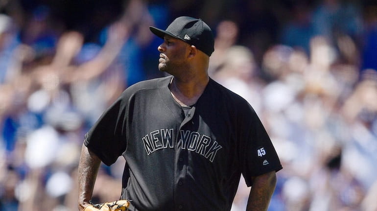 Yankees starting pitcher CC Sabathia reacts after giving up a...