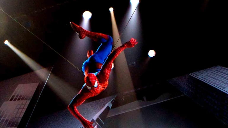 The Spider-Man character is suspended in the air during a...