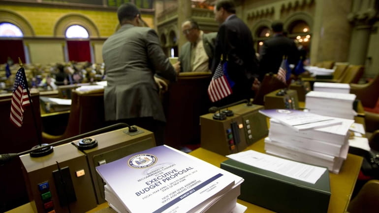 Budget bills sit on a legislator's desk in the Assembly...