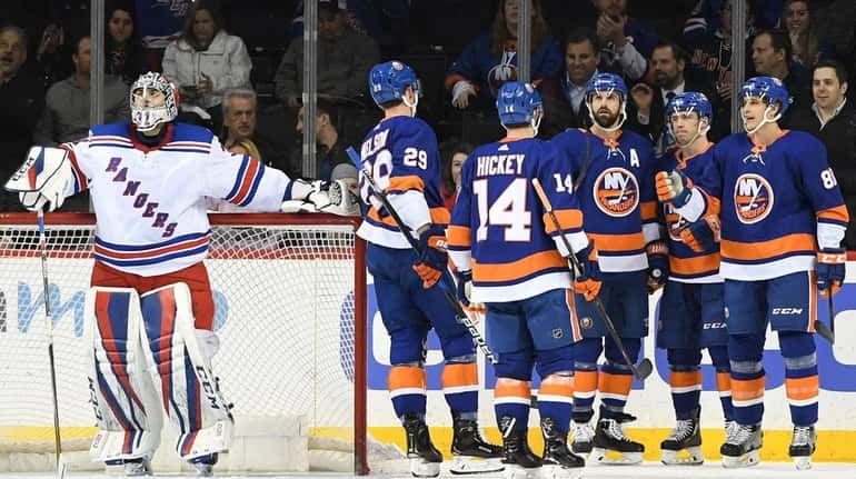 Islanders players celebrate a goal by Islanders center Anthony Beauvillier...