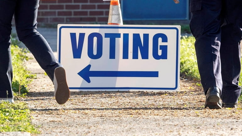 A voting sign outside a polling place.
