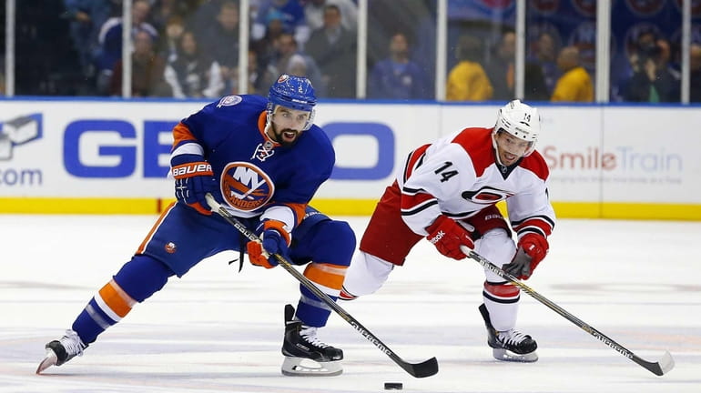 Nick Leddy of the Islanders skates with the puck in...