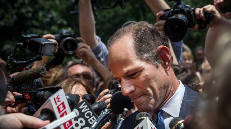 Former New York Gov. Eliot Spitzer is mobbed by reporters...