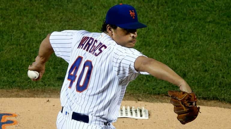 Mets pitcher Jason Vargas delivers during the first inning against the Braves...