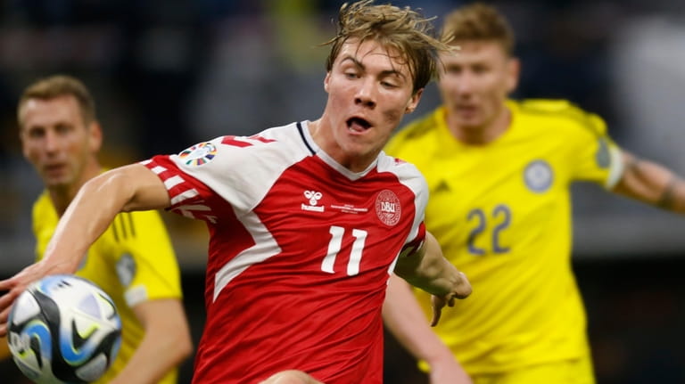 Denmark's Rasmus Hojlund, foreground, battles for the ball with Kazakhstan's...