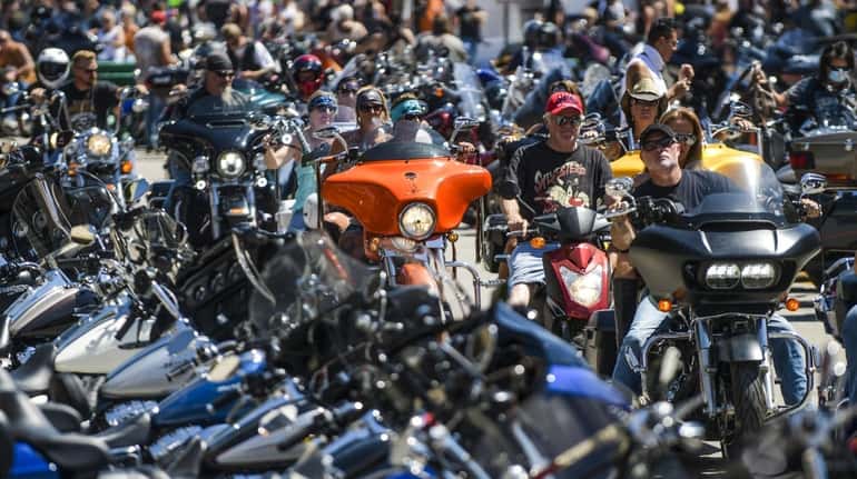 Motorcyclists ride down Main Street during the 80th annual Sturgis...