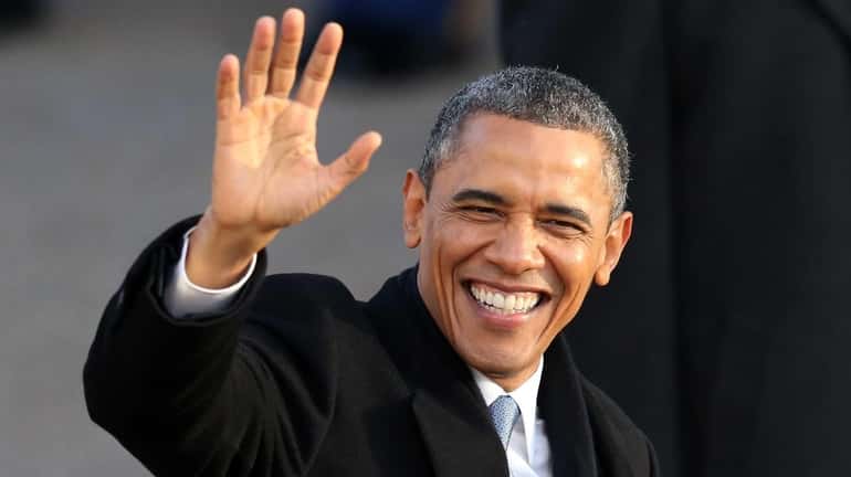 U.S. President Barack Obama waves as the presidential inaugural parade...