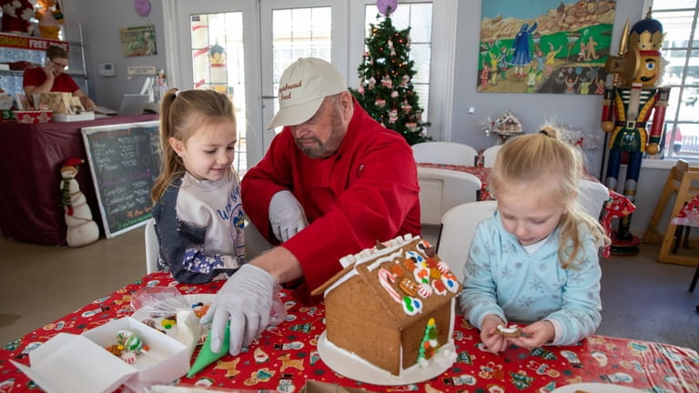 Owner Fred Terry demonstrates gingerbread frosting techniques with Della Frigano,...