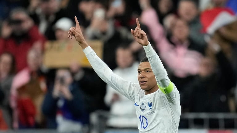 France's Kylian Mbappe celebrates after scoring his side's third goal...