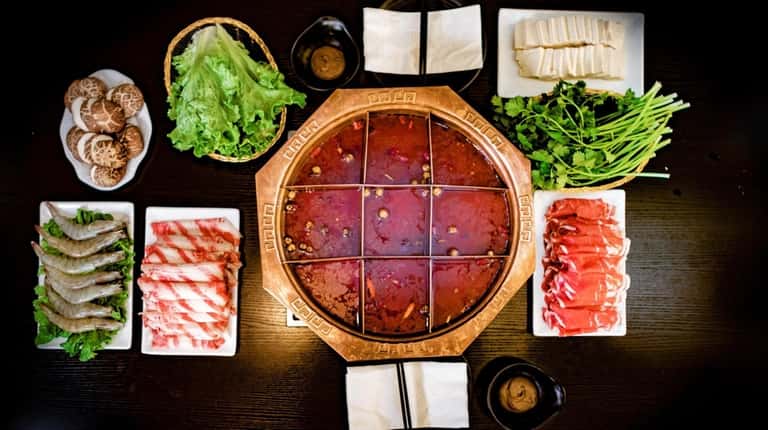 The hot pot with rolled beef and lamb, lettuce, greens,...