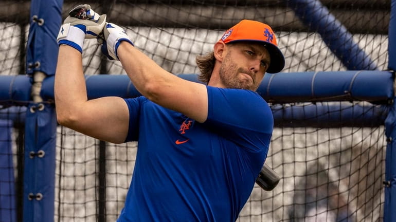Mets infielder Jeff McNeil hits during a spring training workout...