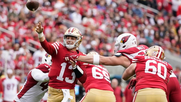 San Francisco 49ers quarterback Brock Purdy (13) throws a touchdown...